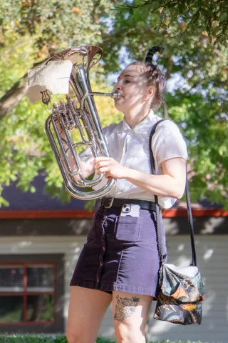A euphonium player smiles mid tune during the parade.