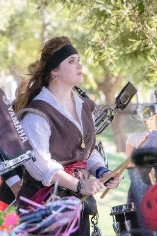 A drummer in pirate costume plays in the marching band.