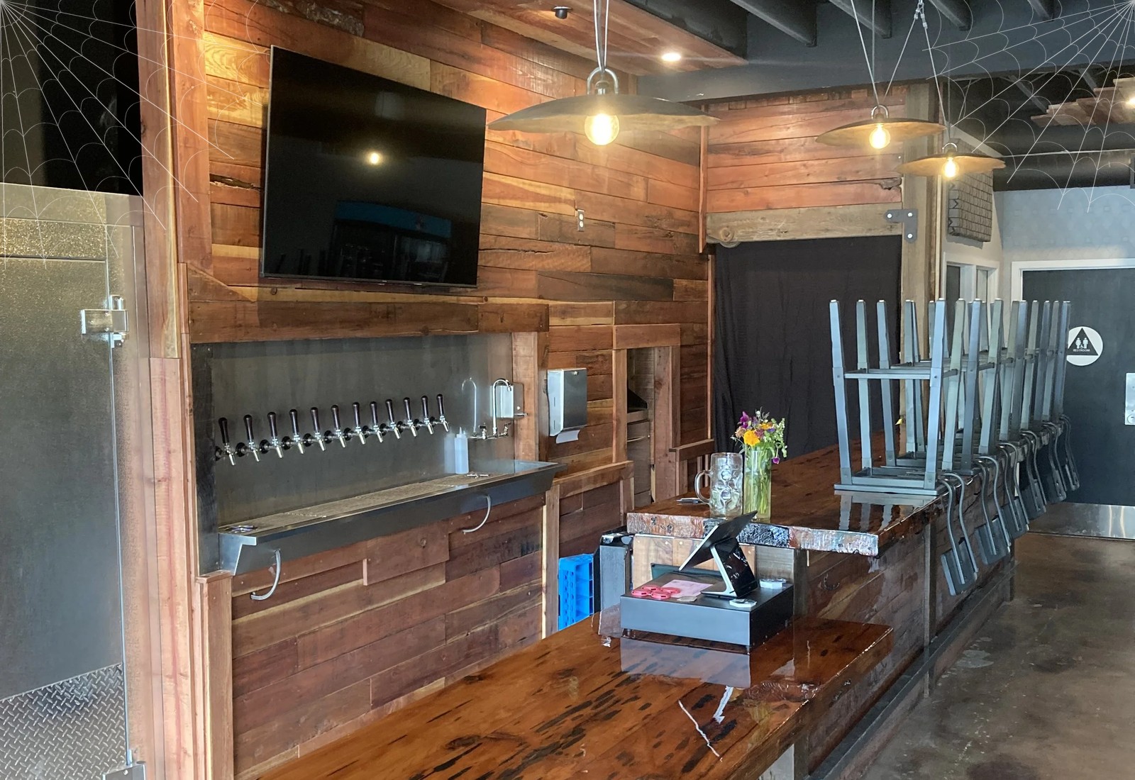 The Local, Dunloe's downtown taproom at 610 3rd Street, with cobwebs
