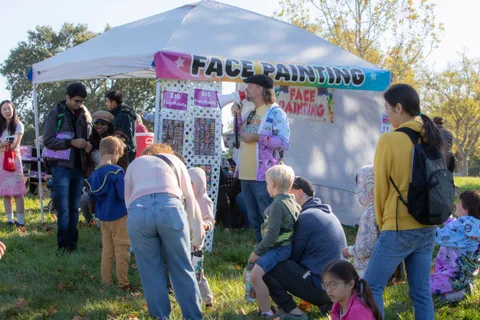 A crowd gathers at the face painting tent