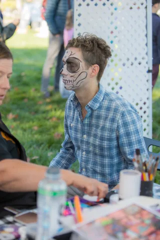 A guest with skeleton face paint at the painting booth