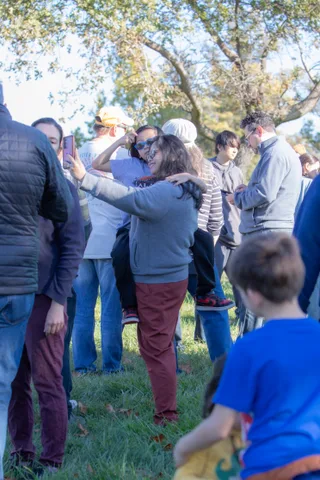 People gather and talk on the grass at the festival