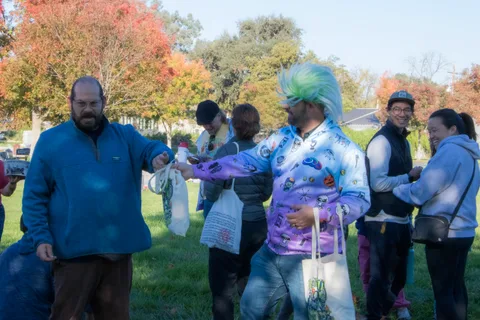 Volunteers hand out bags to guests on the lawn