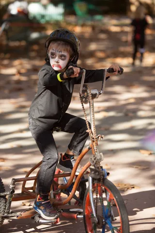 A rider leans hard into a turn on a custom low bike.