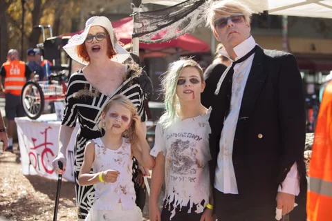 A family in matching zombie costumes poses together, a NorCal Trykers banner visible behind them.