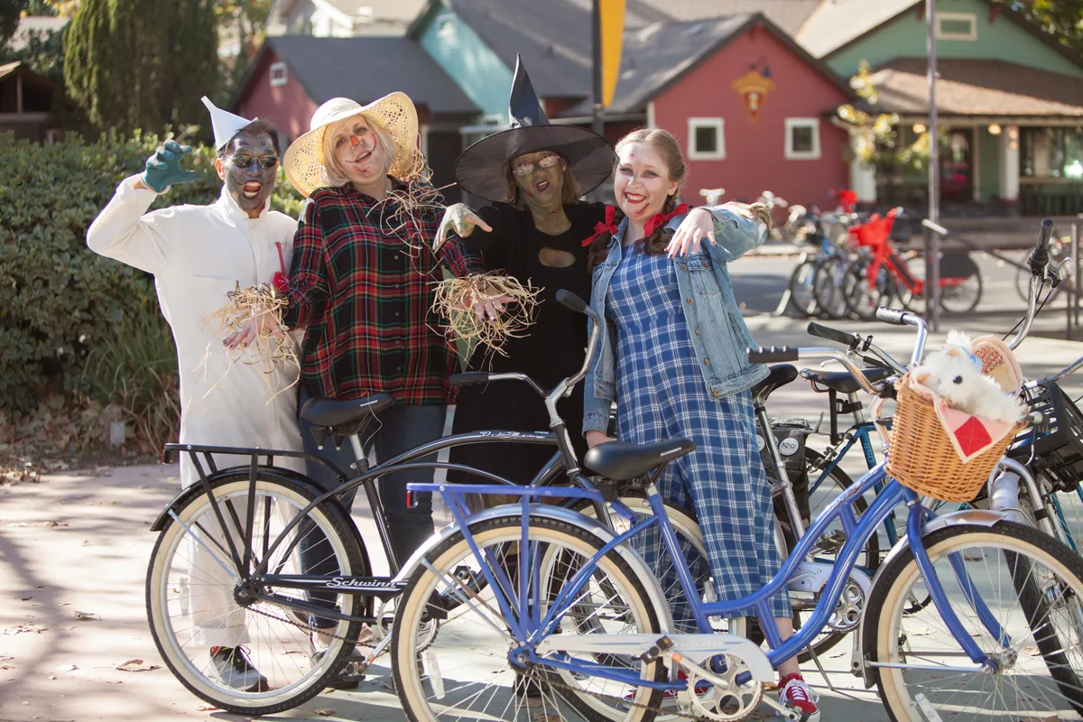 A zombified Wizard of Oz group, Tin Man, Scarecrow, Witch and Dorothy, poses with their bikes.