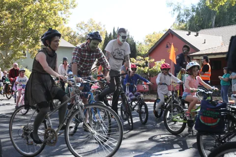 A family group with children rides bikes together along the route.