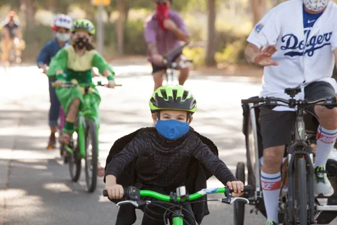 Riders in costume pass by with motion blur in the foreground.