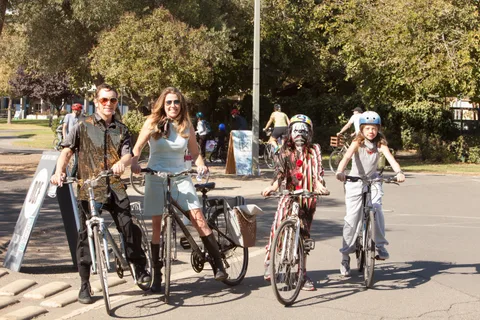 A group in costumes including a mummy wrap stands with their bikes.