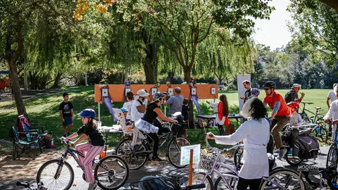 Kids gather at a booth table lined with activity signs.