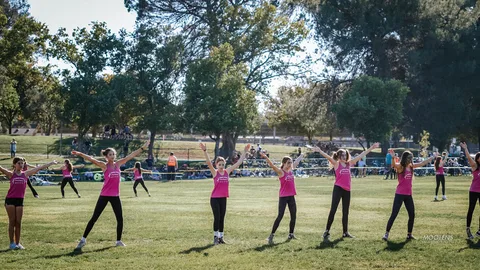 A youth dance team performs in front of a small audience.