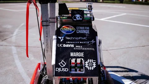 A student robotics cart displays sponsor logos including TechnipFMC and UC Davis.