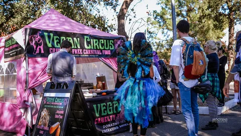 Costumed staff work the Vegan Circus food booth.