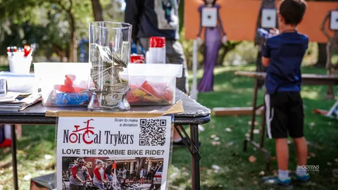 A booth table holds craft supplies and a NorCal Trykers flyer.