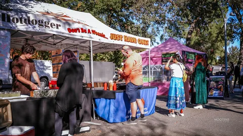 Staff work the counter at the Hotdogger food booth.