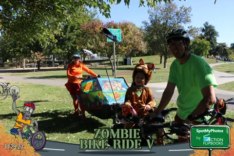 Costumed performers drum atop a colorfully decorated cargo bike float.
