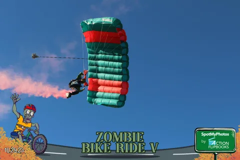 A close view of red and green parachute fabric fills the frame against the sky.