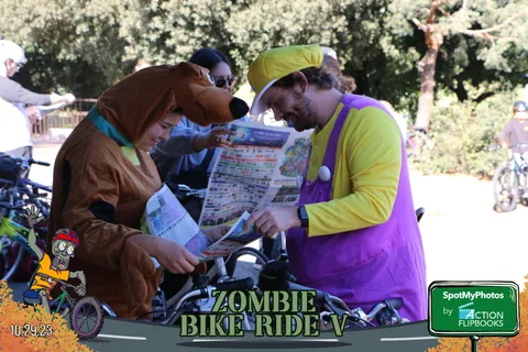 A man in a Scooby-Doo costume comically reads a newspaper.