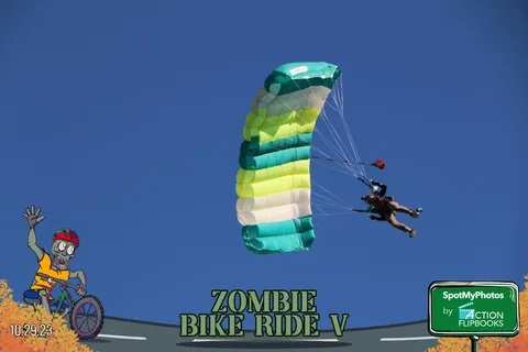 A green and white striped parachute glides across a clear sky.