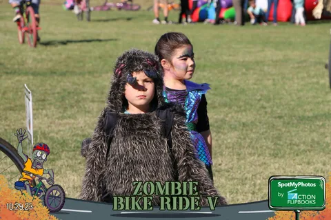 Two children dressed as animals pose together, similar to a nearby frame.