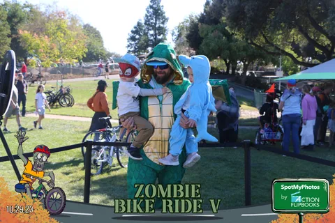 Costumed characters greet children in a wide view of the festival park.