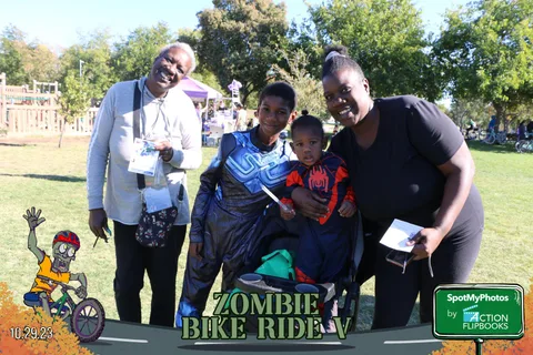 Three family members pose together and smile for the camera.