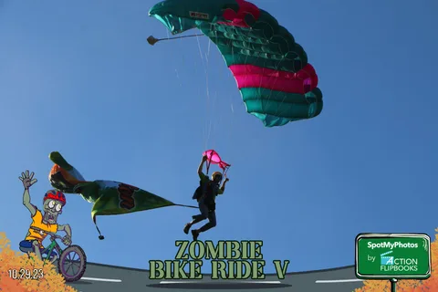 Two colorful parachutes cross paths in a dramatic sky, one trailing red smoke.