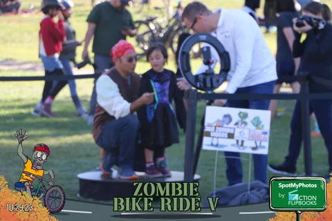 Costumed kids and parents gather around a game station at the festival.