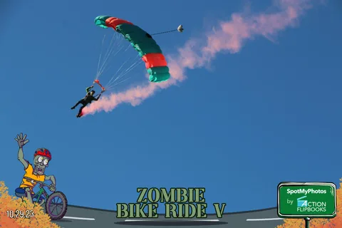 A skydiver dives with a long dramatic smoke trail streaking across the sky.