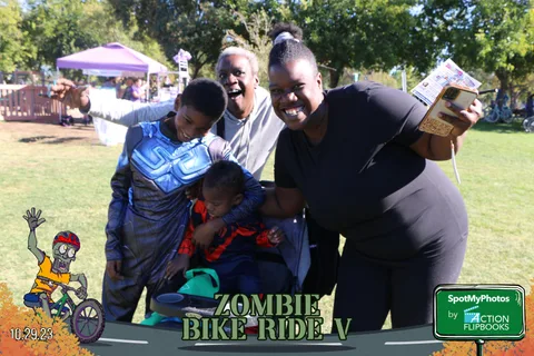 A family embraces closely, with a boy in a blue superhero costume in the middle.
