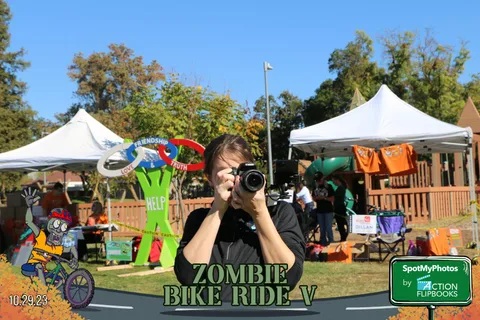 A photographer captures a costumed performer in action.
