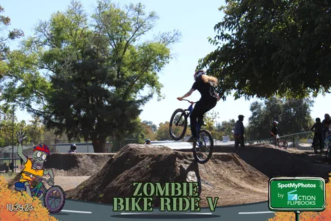 A BMX rider launches high off a jump, clear against the sky.