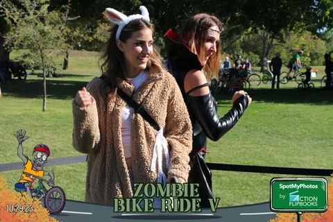 A woman in bunny ears poses with a friend in dark gothic makeup.