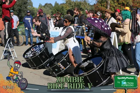 Costumed drummers perform energetically in a festival drumline.