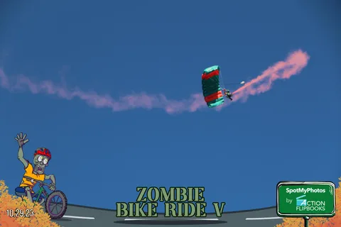 A parachute drifts across the sky with a pink smoke S-curve trailing behind it.