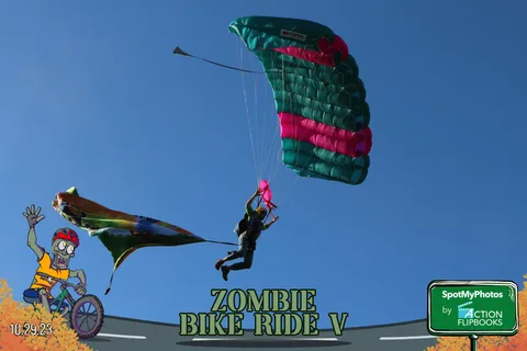 A skydiver descends under a striped canopy trailing pink smoke.