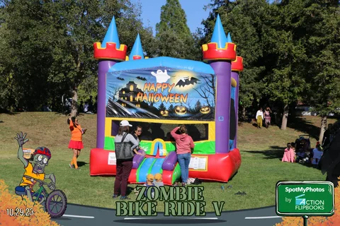 Kids bounce inside an inflatable Halloween castle at the festival.