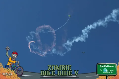 White smoke forms a large loop in the sky as two parachutes fly through it.
