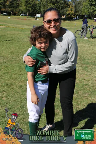A woman hugs a boy closely at the festival.