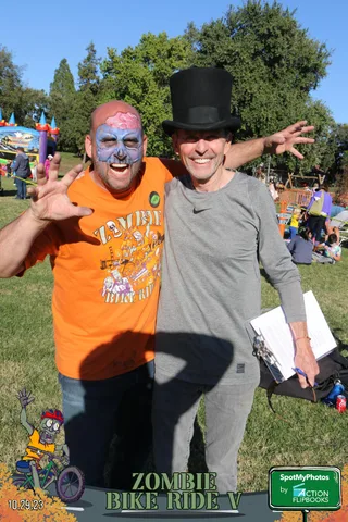 Two people's torsos and hands are visible in an accidental close crop.
