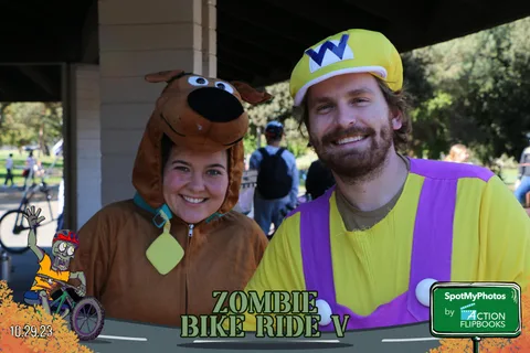 A couple dressed as Scooby-Doo and Shaggy smile together.