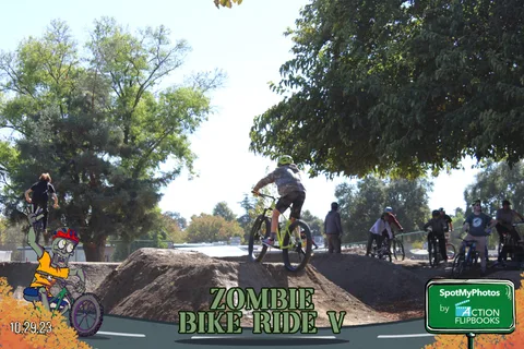 Another BMX rider soars over the dirt jump course against open sky.