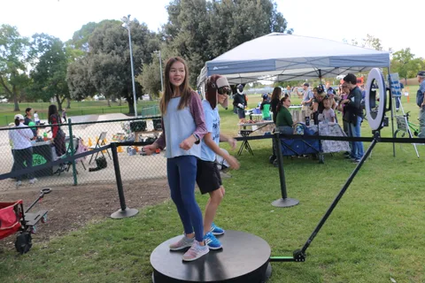 A girl walks toward the festival's photo booth platform.