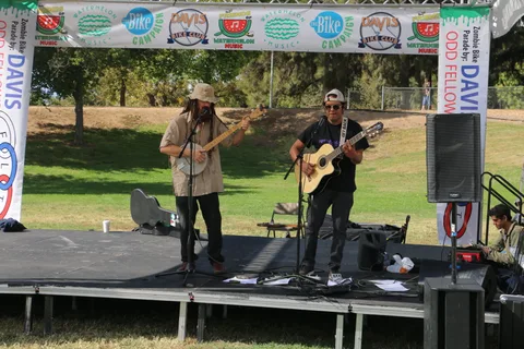 Two musicians perform together on the festival stage.