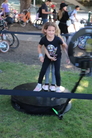 A girl spins and poses on the festival's photo booth platform.