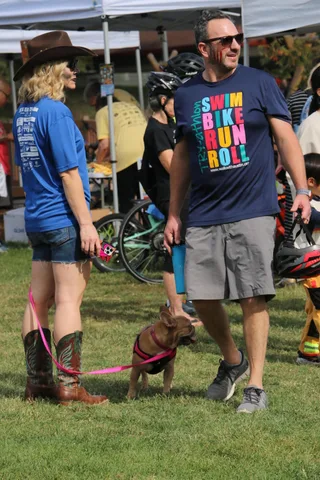 Two men in event t-shirts pose together at the festival.
