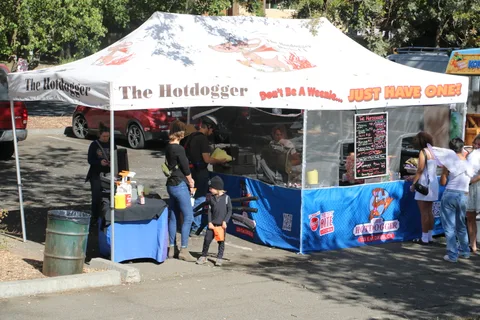 Festival-goers gather at The Hotdogger food booth.