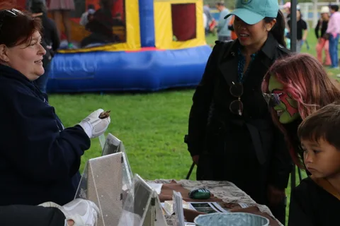 Two women stand at an informational booth table.