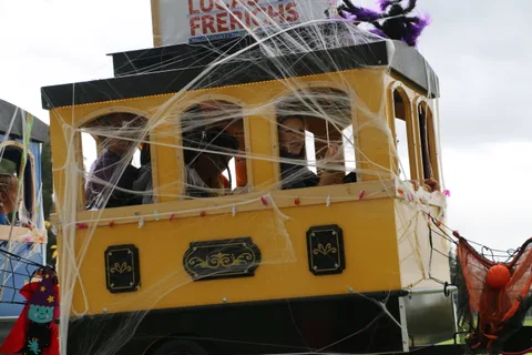 A cobweb-decorated cart with a partly visible sign sits on the path.