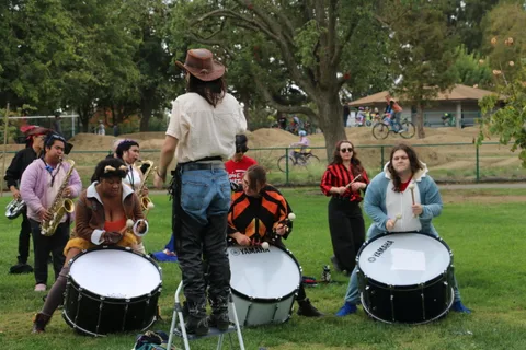 Trumpet players perform as part of the costumed drum corps.